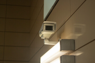Fototapeta na wymiar Surveillance video camera. Security system in the subway. Video recording in a public place. Citizen recognition system.