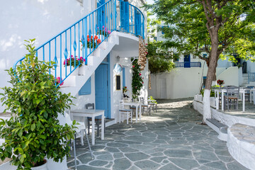 Greece, Folegandros island.  Chora square. Traditional tavern tables and chairs outdoors.