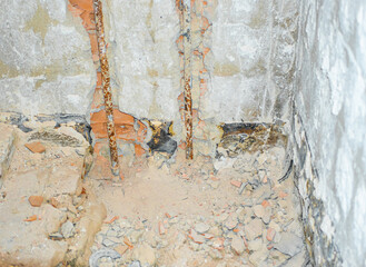 Old rusty water pipes ready to be replaced. Concept of renovation of an old home bathroom.
