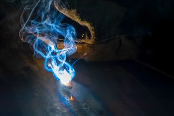 MMA welding. Welding with an electrode close-up. A welder welds large diameter pipes with manual...