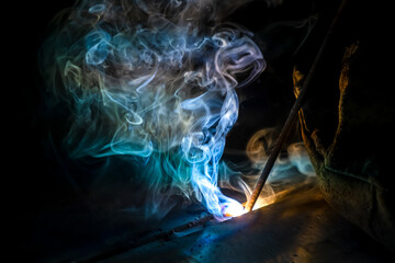 MMA welding. Welding with an electrode close-up. A welder welds large diameter pipes with manual...