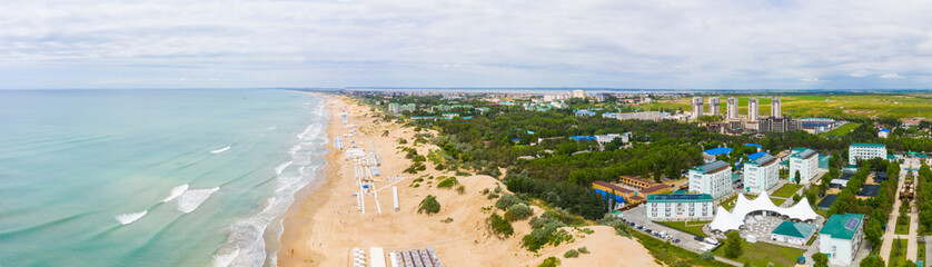 Fototapeta na wymiar A picturesque panorama of the sea coast with a sandy beach in a resort near the city of Anapa and the village of Vityazevo.