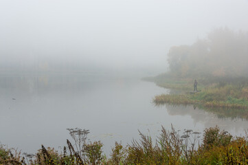Fototapeta premium In the thick fog on the river , the shore is barely visible