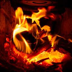 Firewood burning with a bright flame in the stove