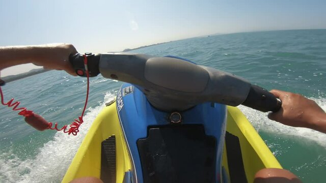 Happy man riding water jet in speed on sea, pov