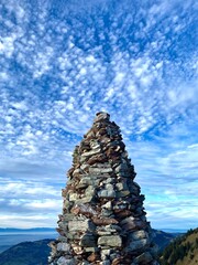 Tall stone tower on top of the mountain.