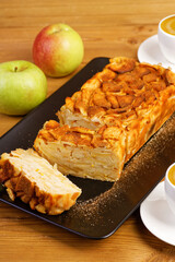 Closeup french apple cake. Homemade apple clafouti on wooden table. Shallow focus.