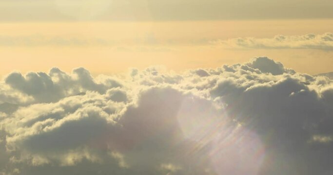 stationary locked off footage with lens flare above the cloud line at sunset on the island of Maui,Hawaii, USA