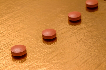 
pills, gold background, red, brown, round, health, vitamins, treatment, antiviral, drugs, dosage, stress, illness, recovery, medicine