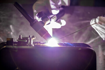 TIG welding. Welding the fuel tank of a motor pump by electric arc welding in argon shielding gas.