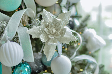 A beautiful New Year's interior with a large, decorated with toys standing near the fireplace.