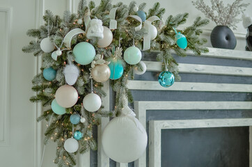 A beautiful New Year's interior with a large, decorated with toys standing near the fireplace.