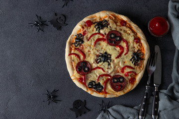 Halloween funny pizza with spiders, Creative idea for Halloween pizza on dark gray background, Top...
