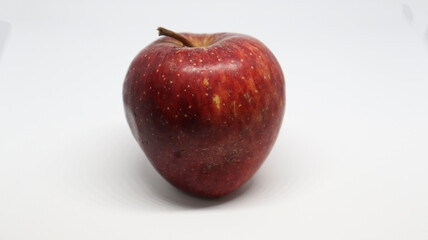 The red apple is on a white background