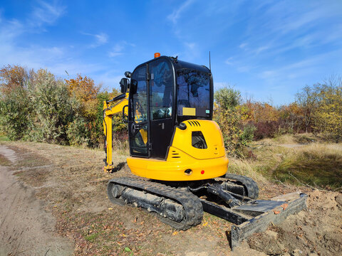 JCB digger or excavator performs excavation work outdoors