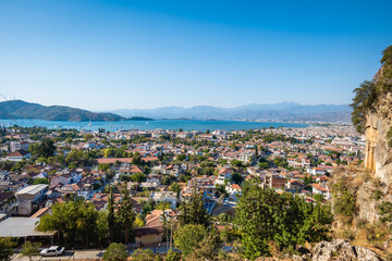 Obraz premium Fethiye landscape and cityscape, aerial view of the popular resort city of Fethiye and the Bay of the Mediterranean sea, Turkey.