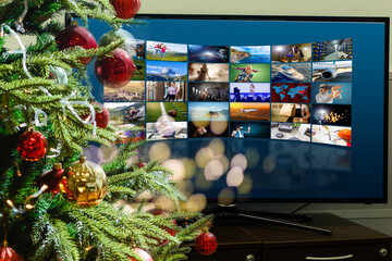 Virtual Christmas day house party. video conferencing Young man having video call via computer in the home office Online team gift opening conference calling.