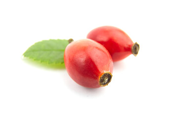 Rose hips briar berries with fresh green leaves isolated on white