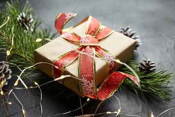 Christmas gift box with light garland on dark