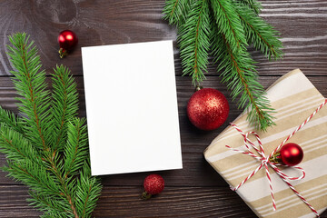 Fototapeta na wymiar Christmas greeting card mockup with festive red balls decorations and gift box
