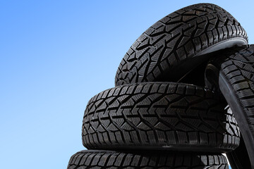 Winter car tires. Group of tires for winter driving on a blue background.