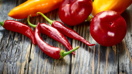 Colorful peppers on the wooden background. Copy space.