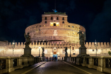 Fototapeta na wymiar Castel Sant'Angelo at night, Rome, Italy. Medieval castle and Renaissance bridge.