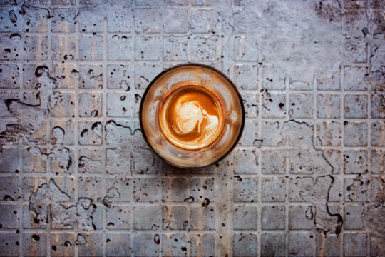 Glass of Hot Coffee Latte on Grungy Concrete Table in Loft Industrial Style Cafe. Table Top, Directly above view