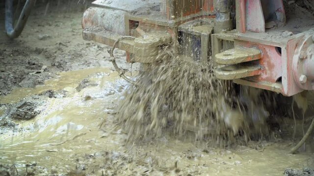 Closeup of drill in the process of drilling a water well with a winding drill, construction site concept