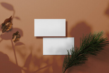 Clean minimal business card mockup on background with conifer
