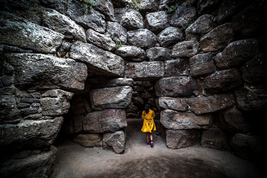 Woman visiting an ancient nuraghe in Sardinia