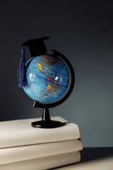 Graduation hat on globe model. Education and scholarships concept