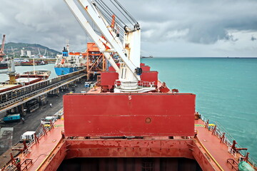 Cargo terminal for unloading steel plates from bulk carrier by ships cranes.  Port of Cigading....