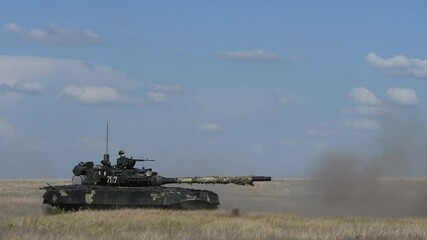 Heavy armored Ukrainian T-80 tank hooting in sand side view. Powerful army technology created for security and defense. Armed military vehicle training to defend people. 4k UHD footage.