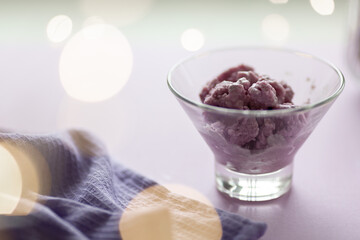 lavender ice cream on the background of festive lights