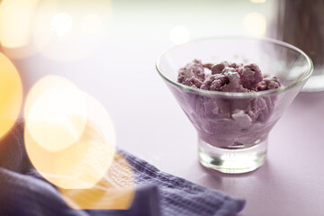 lavender ice cream on the background of festive lights