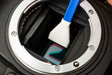 Cleaning the sensor of a digital camera with a microfiber swab