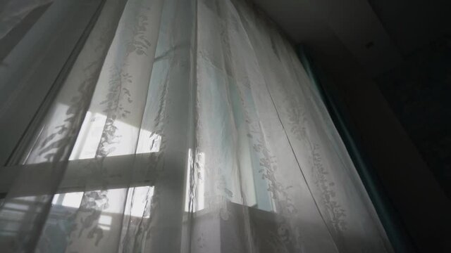 White transparent curtain hanging on bedroom window with plastic frame close side view