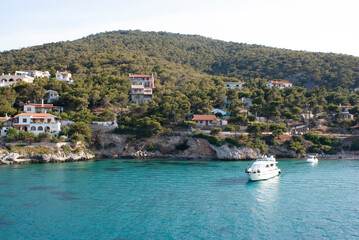 Fototapeta premium Secluded, beautiful Agistri island Greece Coastal scene. View of pine clad coastal cliffs and sea. Landscape aspect view.