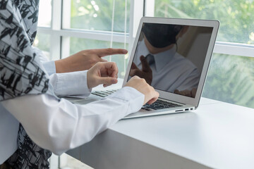 asian business people group wearing protection face mask working communicating with laptop computer at modern office desk together, digital creative online marketing, business meeting startup concept