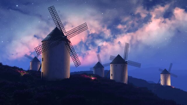 Multiple old, vintage, Spanish windmills rotating slowly at night. 4K HD