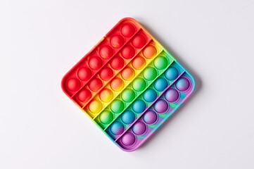 colorful anti-stress pop it toy in the form of a diamond on a white background