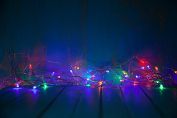 Fototapeta na wymiar Multicolored festive garland glows in the dark.