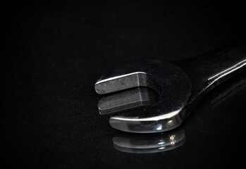 Work tool of the wizard. Wrenches on black surface. Free space for text.