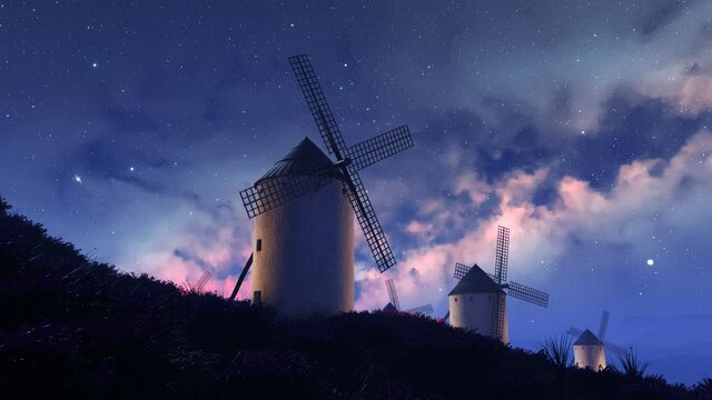 Multiple old, vintage, Spanish windmills rotating slowly at night. 4K HD