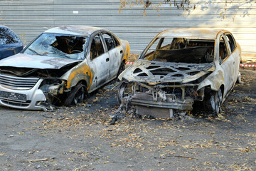 Metal frames of two burnt out cars, sabotage arson or short circuit.