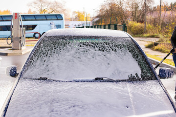 Blue car in foam at a car wash