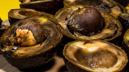 Close up Bad Avocado. Ugly Tropical fruits. Contaminated Avocado halfs. Necomestibile Fruits. Details Overripe Avocado. Unhelthy food Concept.