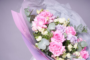 Close-up of a colorful bouquet of flowers. Big pink roses. On a light background, top view, copy space. High quality photo