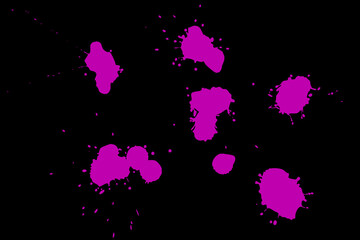 Pink blot on a black background. Spots of paint on a piece of paper.